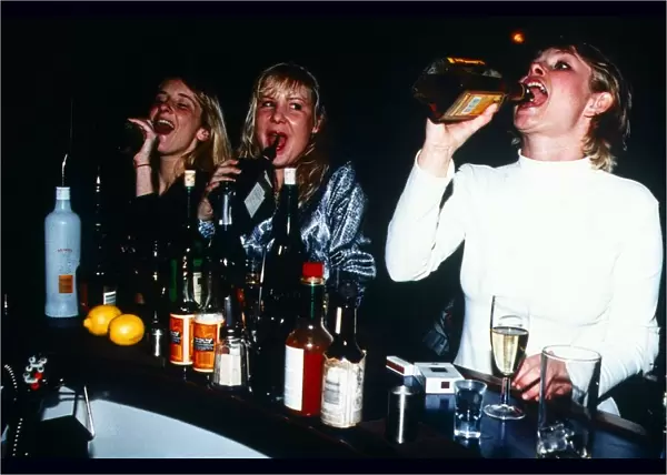 Young Women drinking straight from the bottle in a Bar - January 1996 Girls