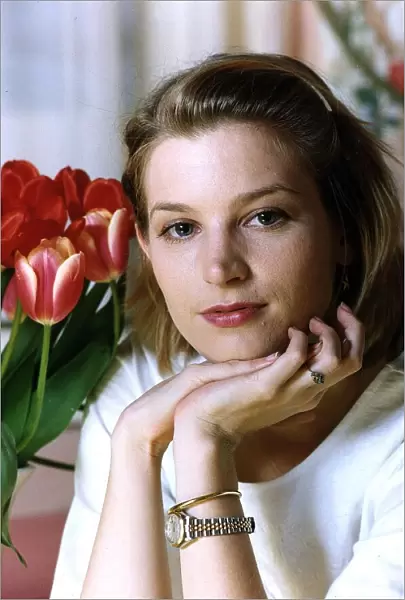 Bridget Fonda wondering with red roses in the background