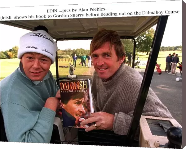 Kenny Dalglish shows a copy of his autobiography Dalglish My Autobiography to Gordon