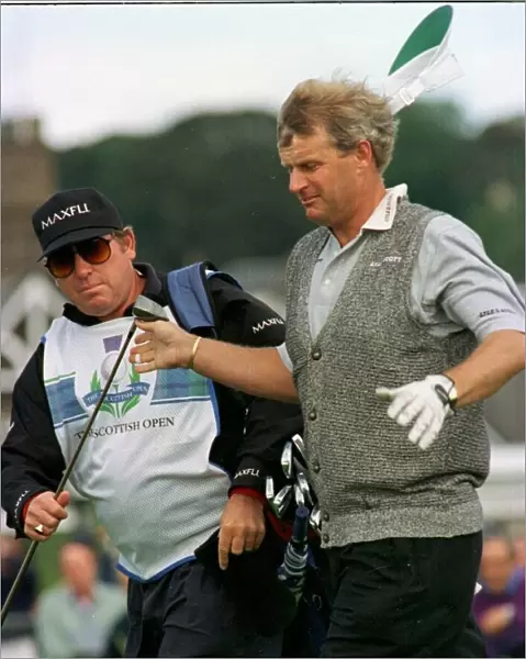 Sandy Lyle golfer hands his driver to his caddy on the final day of the 1996 Scottish