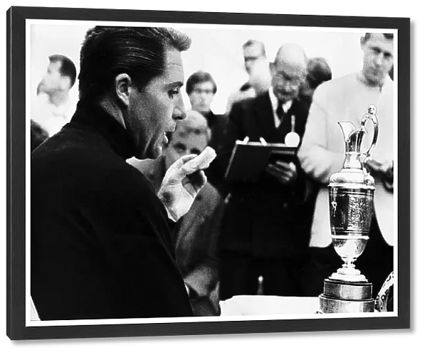 Gary Player eats a banana and contemplates the trophy he has just won at the British Golf
