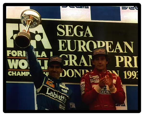 Damon Hill and Ayrton Senna on the winners podium take the applause as winners