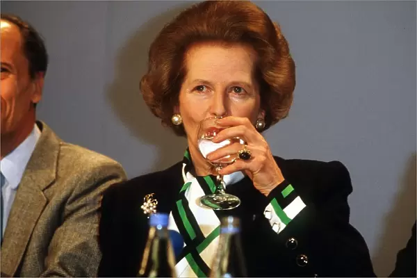 Prime Minister Margaret Thatcher drinking a glass of water at a conference May 1987