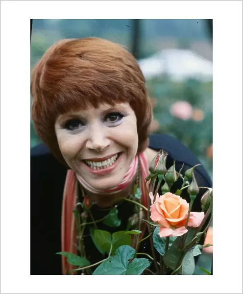 Judy Carne standing next to roses July 1979