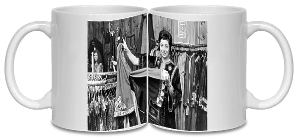 Betty Van Gelder, owner of a dress shop in Hampstead, wearing one of her own velvet