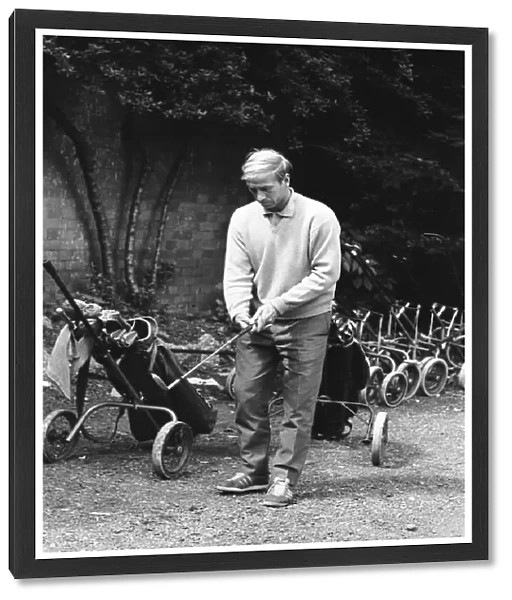England footballer Bobby Charlton chosses his club as enjoys a round of golf during an