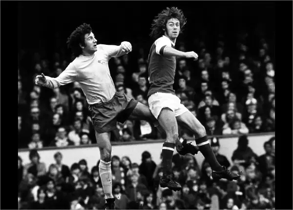 Charlie George Football Player March 1973 jumps with Roy McFarland for the ball