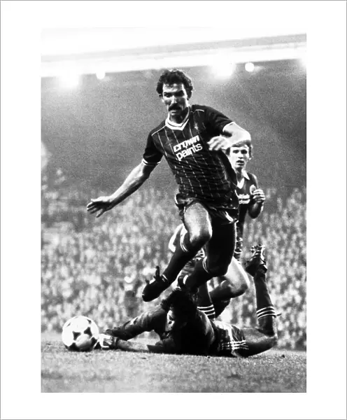Graeme Souness of Liverpool jumps over Brighton goalkeeper Graham Mosely during the two