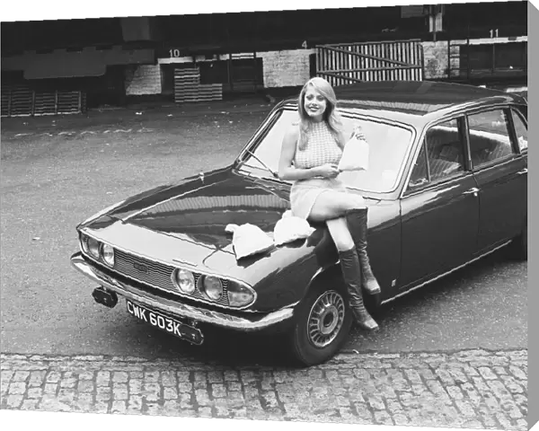 Reveille model seen here posing with a Triumph 2000 which is top prize in the Reveille