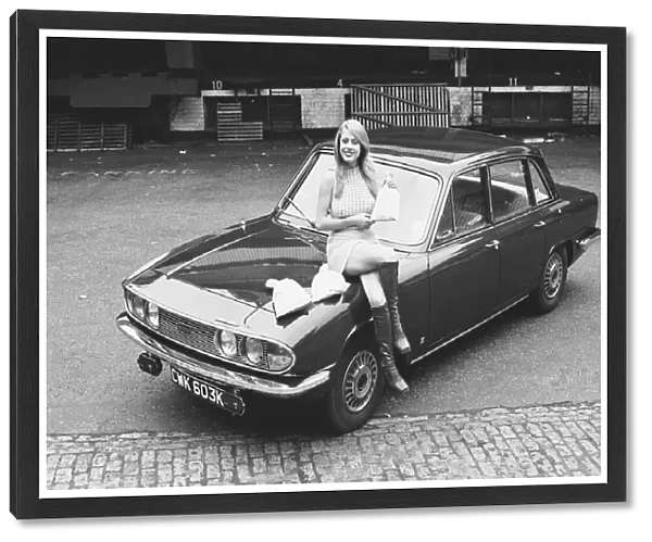 Reveille model seen here posing with a Triumph 2000 which is top prize in the Reveille
