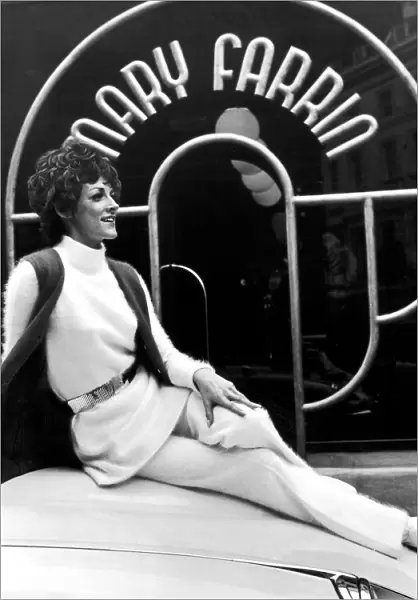 Fashion designer Mary Farrin wearing her own white knitted angora dress over matching