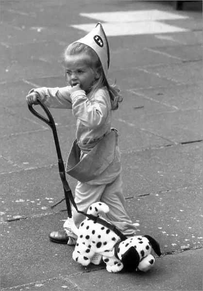 2 year old Thea Behbahani tries out a new plastic trike and nodding dog