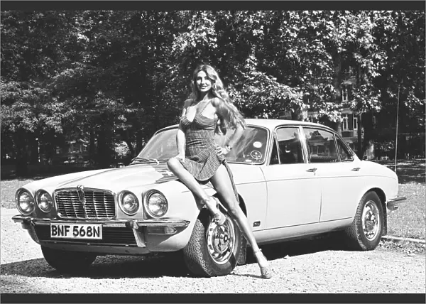 Reveille model Marilyn Coles seen here posing with a Jaguar