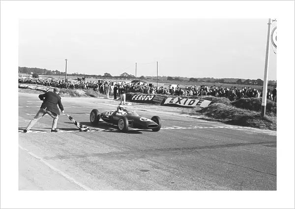 Peter Arundell in his Lotus 22 takes the checkered flag to win the Molyslip Trophy  /  IV