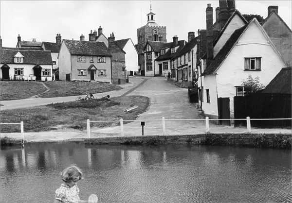 Children fishing for tadpoles and minnows in the village pond at Finchingfield Essex