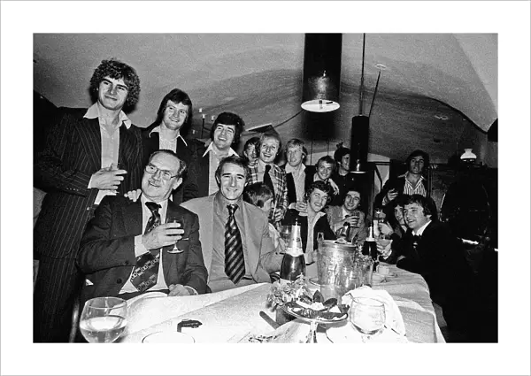 Manager Malcolm Allison with his Crystal Palace team relaxing in a bar drinking champagne