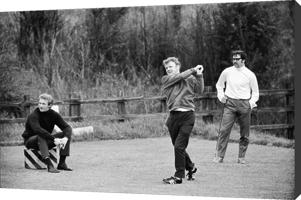 Scotlands Billy Bremner tees off watched by Denis Law during a game of golf at