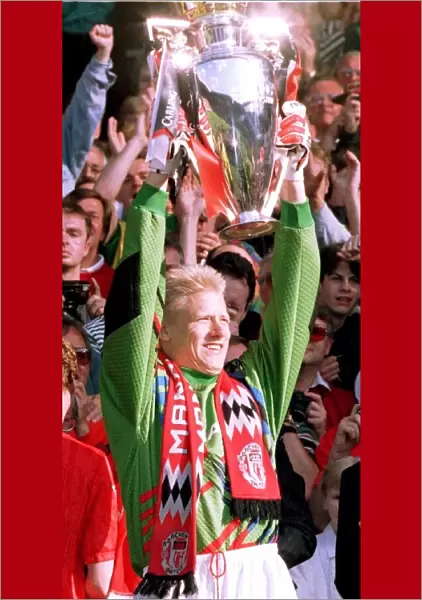 Goalkeeper Peter Schmeichel holds the Carling Premierhip Trophy won by Manchester United