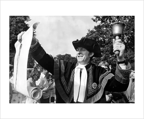 Dressed in a black and gold costume, Town Crier Douglas Knott