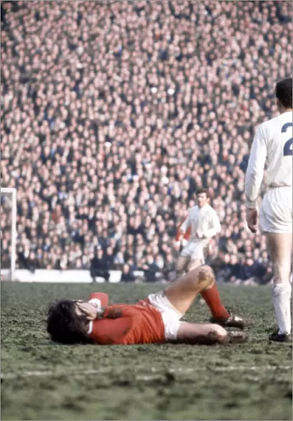George Best of Manchester United lies on the ground injured during the FA Cup Semi Final