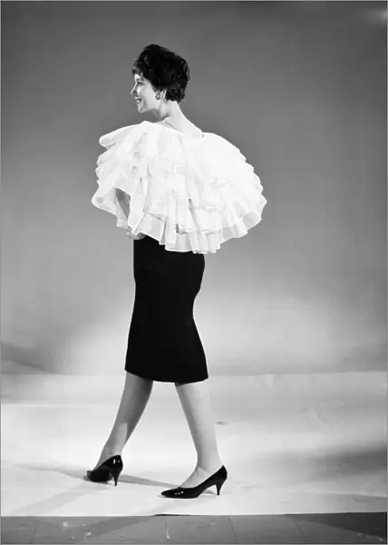Clothing: Fashion: Capes: Woman wearing frilly cape that can be adapted to become a skirt