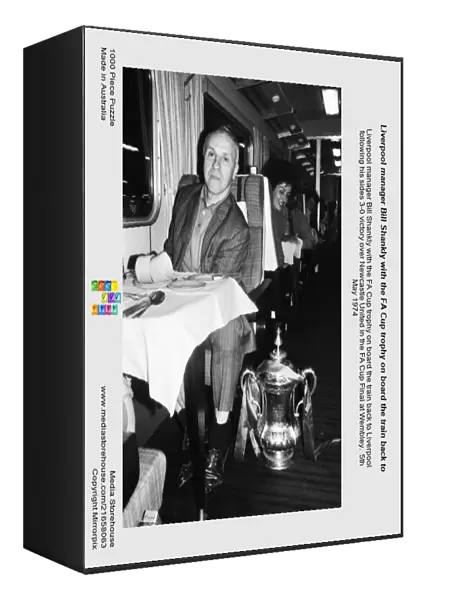 Liverpool manager Bill Shankly with the FA Cup trophy on board the train back to