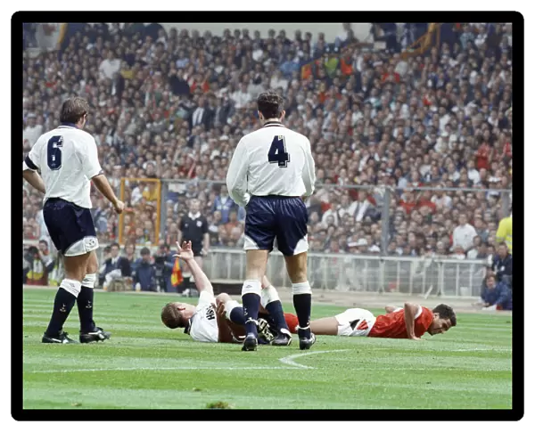 Paul Gascoigne of Tottenham Hotspur Football Club lies on the ground waving to