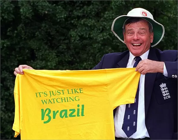 World famous cricket umpire Harold Dickie Bird holding a T-Shirt that barnsley fanswear