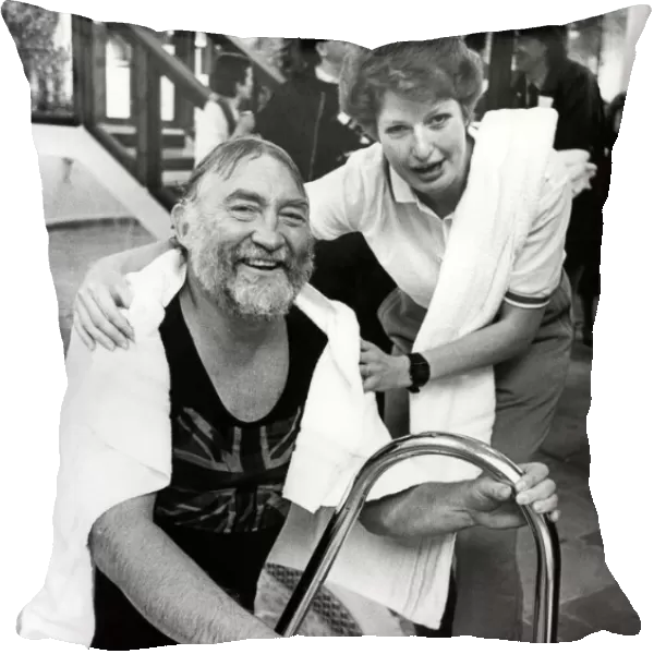Leisure complex attendant Phillipa Seccombe helps David Bellamy out of the pool at
