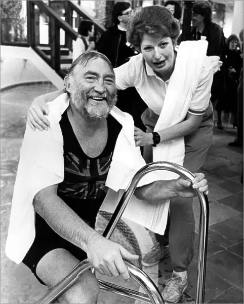 Leisure complex attendant Phillipa Seccombe helps David Bellamy out of the pool at