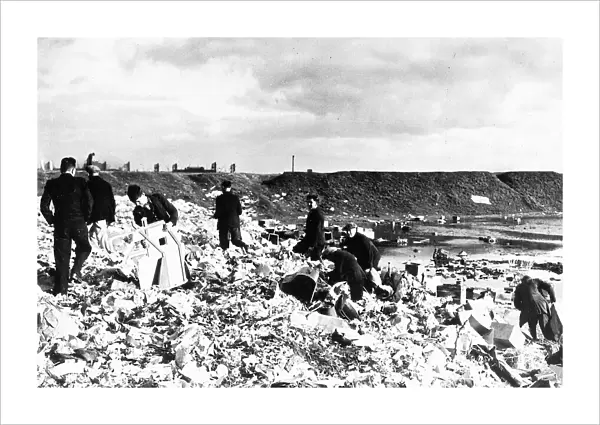 General view of unemployed workers from Cardiff picking over a rubbish tip in 1938