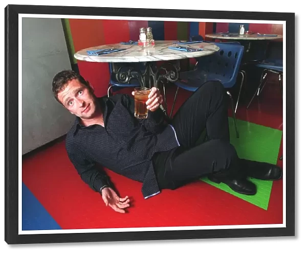 Mark Wogan son of Terry Wogan under the table with his apple juice