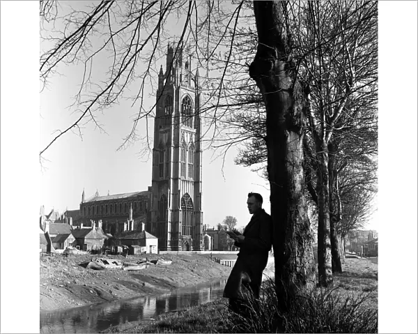 A man reading near St Botolphs Church in Boston, Lincolnshire. 2nd April 1953