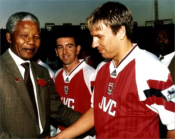 Paul Merson, football player for Arsenal FC, shakes hands with the President of South