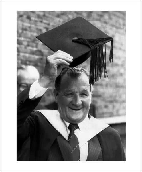 Former Liverpool manager Bob Paisley raises his mortar board after being made an honorary