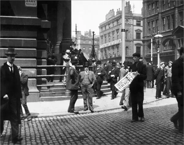 A newspaper seller in Bank Street, Manchester. Circa 1905