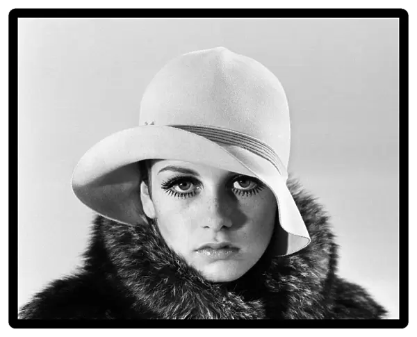 Model Twiggy posing in the studio wearing a hat. December 1966