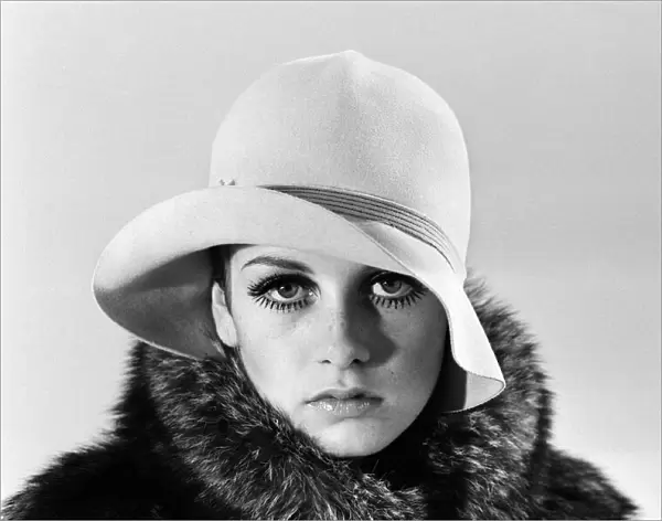 Model Twiggy posing in the studio wearing a hat. December 1966