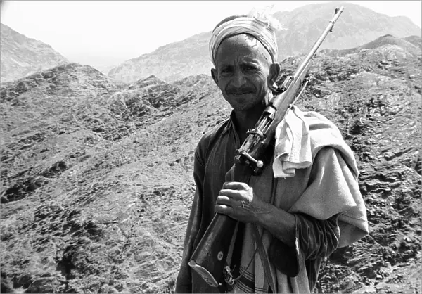 Old Pathan tribesman carries a old bolt action rifle at the Khyber Pass on the border