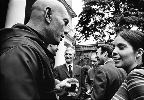 Actress Vivienne Ventura talks to Yul Brynner (left) with footballers Jimmy Greaves