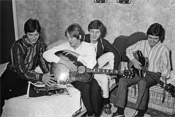 The Small Faces pop group pictured in a provincial hotel room as they watch their latest