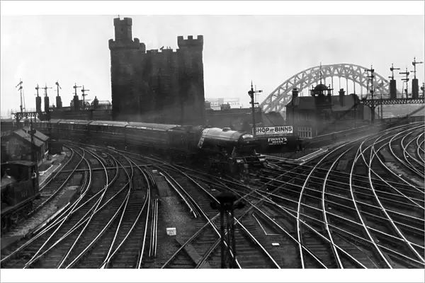 With an ancient and modern background - the Flying Scotsman express approaching Newcastle