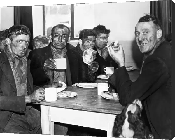 A group of miners enjoying a meal after the opening of a pithead canteen at Isabella Pit