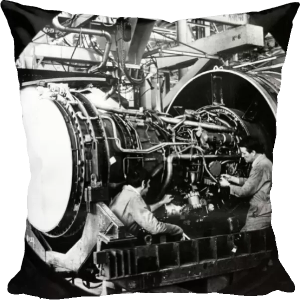 Engineers work on a Pratt and Whitney jet engine from Boeing 747 at Nantgarw