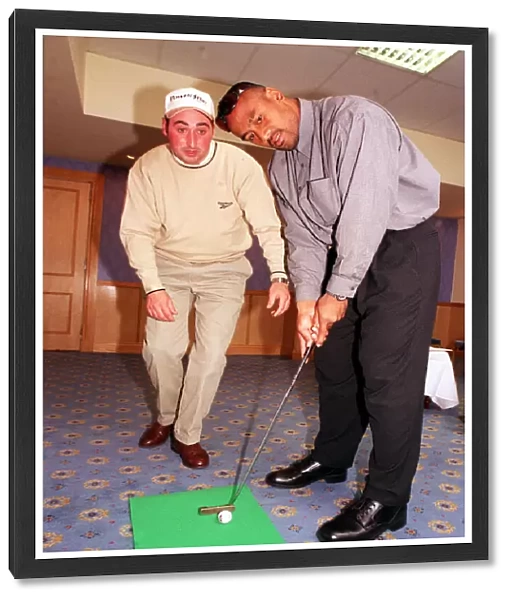 Jonah Lomu Rugby player October 1999 playing golf putting Receiving lesson from Kevin