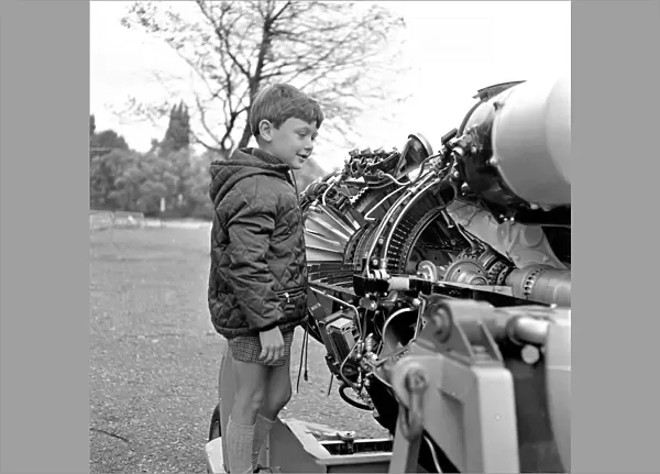 A young boy (unidentified) enjoys inspecting an engine at the RAF Display at Caversham