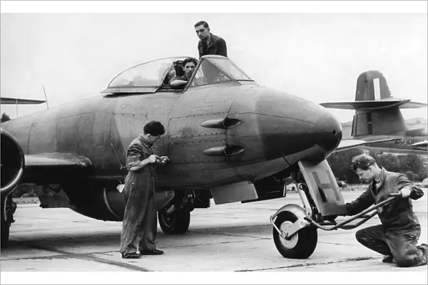 A Gloster Meteor ground crew make last minute check before taking off for the gunnery
