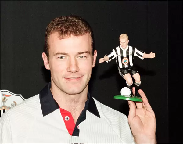 Alan Shearer holding his soccer figure from the Soccer Superheroes collection