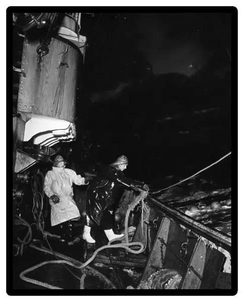 Trawlermen at work at sea on trawlers