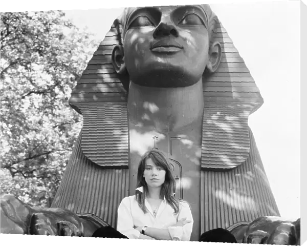 Francoise Hardy, french singer pictured seated between the feet of a sphinx